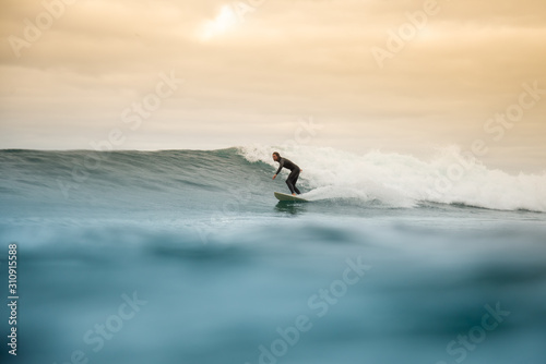 surfer riding waves on the island of fuerteventura