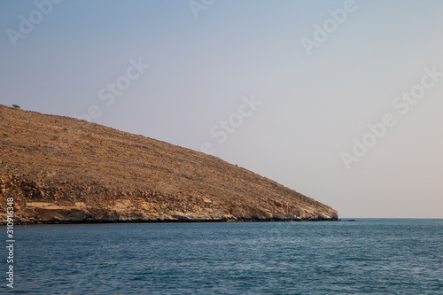 mountains and rocks by the indian ocean in oman