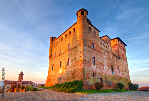 Golden hour view of Grinzane Cavour castle, historical landmark, village in Langhe region, Cuneo, Piedmont, Italy.  photo