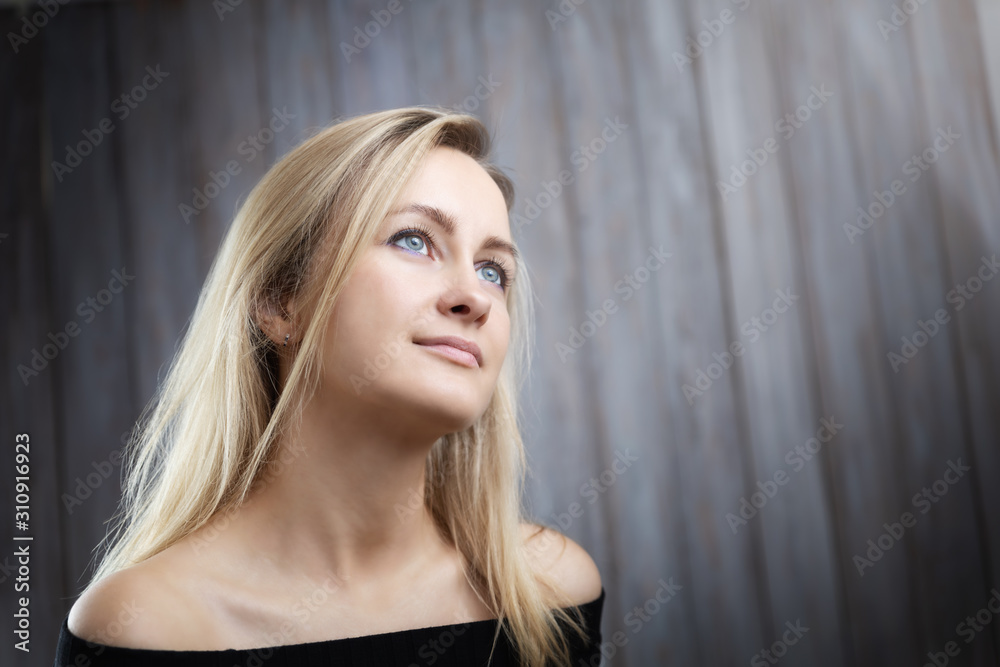 Fototapeta premium Happy beautiful young blond woman portrait with wooden background
