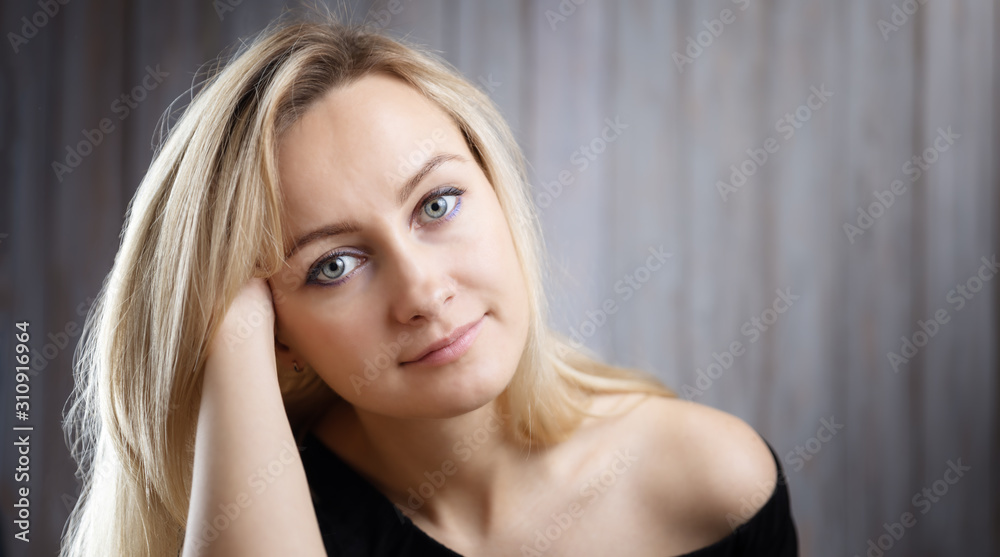 Happy beautiful young blond woman portrait with wooden background Happy beautiful young blond woman portrait with wooden background