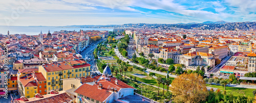 Nice, France - December 1, 2019: Colorful aerial panoramic view over the old town, with the famous Massena square and the Promenade du Paillon, from the roof of Saint Francis tower photo