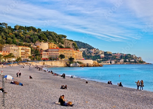 Nice, France - December 1, 2019: view of the beach and walkway promenade on a clear winter day