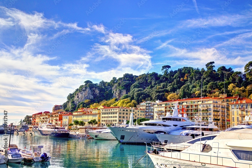 Nice, France - December 02, 2019: View of the commercial Lympia port in a clear winter morning, with the Castle hill on the background