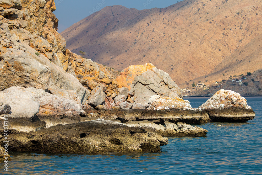 mountains and rocks by the indian ocean in oman