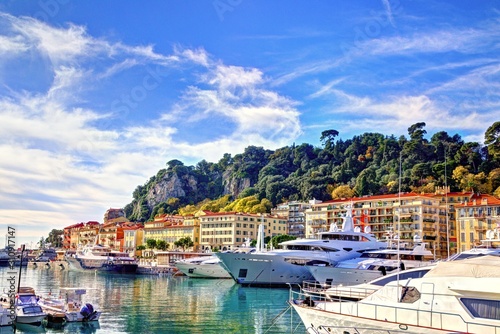 Nice, France - December 02, 2019: View of the commercial Lympia port in a clear winter morning, with the Castle hill on the background