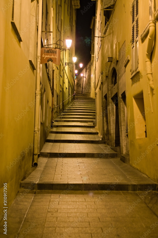 Nice, France - December 02, 2019: night views in the Nice old town narrow street and alleys. Selective focus