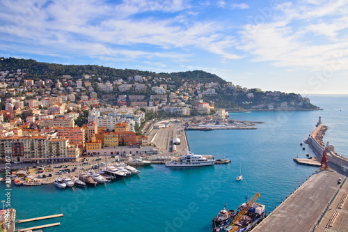 Fototapeta Naklejka Na Ścianę i Meble -  Nice, France - December 1, 2019: Panoramic aerial view over the Lympia port of Nice, France, on a clear winter morning, with Mount Boron hill on background