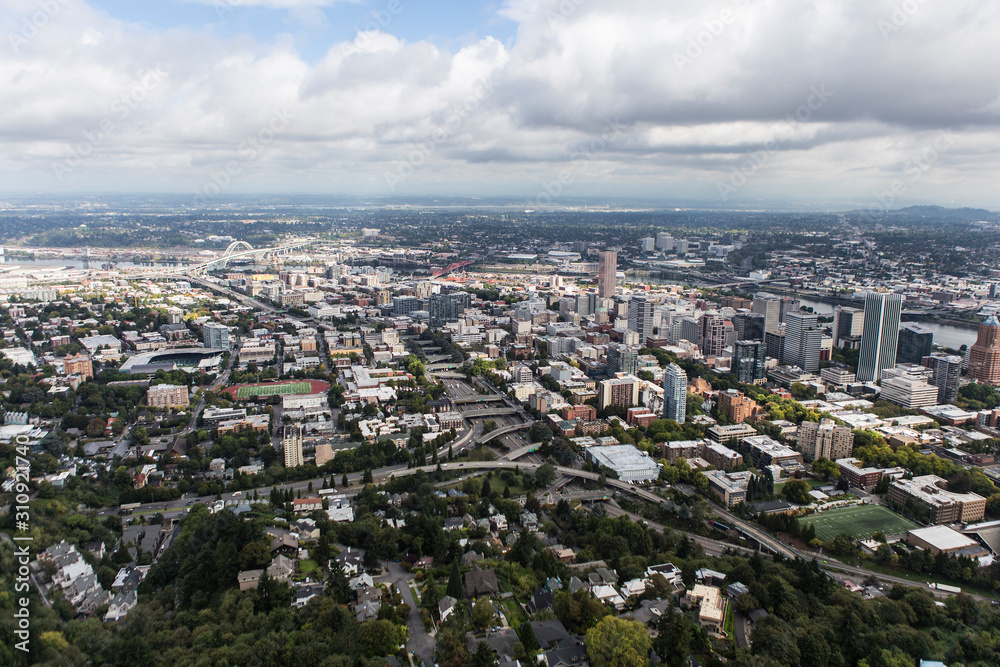 Aerial view of the buildings, homes, streets and bridges near downtown Portland, Oregon, USA.