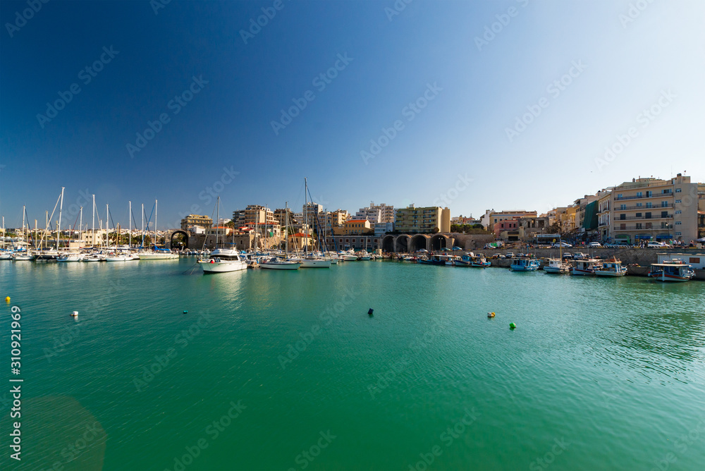 Day foto of old venetian harbor with boats in Heraklion