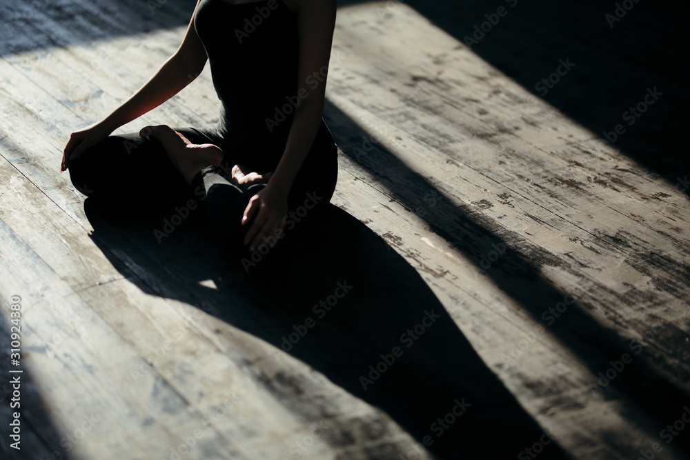 asian young woman sitting in Lotos pose. Businesswoman practicing meditation in yoga hall after finish working. Time for Yoga and relaxation asian young woman sitting in Lotos pose. Businesswoman practicing meditation in yoga hall after finish working. Time for Yoga and relaxation