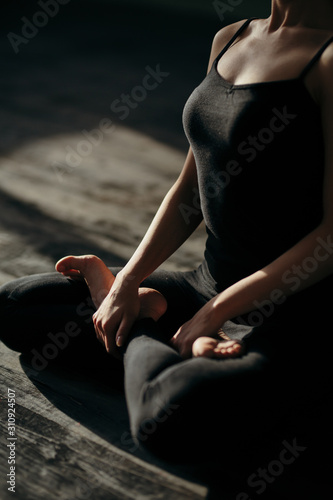 asian young woman sitting in Lotos pose. Businesswoman practicing meditation in yoga hall after finish working. Time for Yoga and relaxation