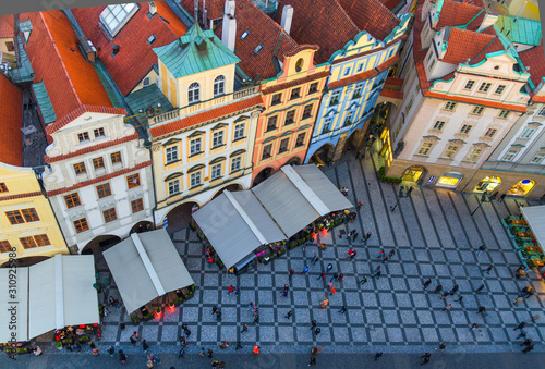 Top view of Prague Old Town (Stare Mesto) historical city centre. Row of buildings with colorful facades and red tiled roofs on Old Town Square Staromestske namesti in evening, Bohemia, Czech Republic