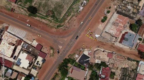 Aerial drone birds-eye view of T Junction on Kololi Road in Serrekunda The Gambia Africa with moving traffic and cars photo