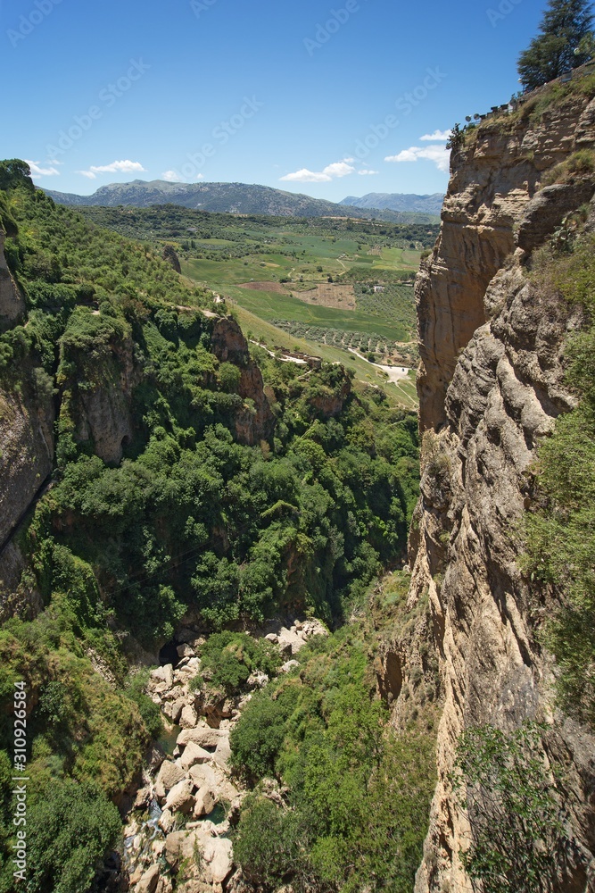 View from Ponte Nuevo (the New Bridge) in Ronda, Spain. This bridge spans the 120-metre-deep (390 ft) chasm that carries the Guadalevín River and divides the city of Ronda