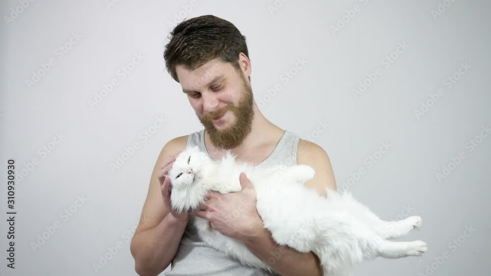 Bearded guy kisses her beloved cat.Heterochromia eyes Bearded guy kisses her beloved cat.Heterochromia eyes
