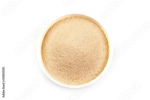 Semolina in bowl, isolated on white background