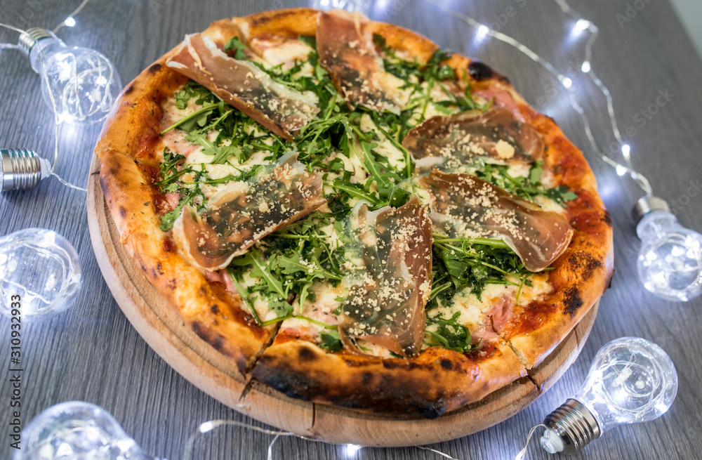 Delicious tasty pizza with ingredients on wooden table