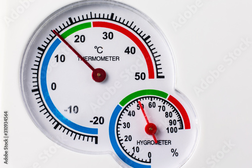 Analog hygrometer and thermometer. Round scale. Concept uncomfortable conditions photo