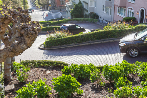 San Francisco, California, USA - April 2, 2018: Cars driving on Lombard Street with eight hairpin turns  in San Francisco, the crookedest street in the world.  