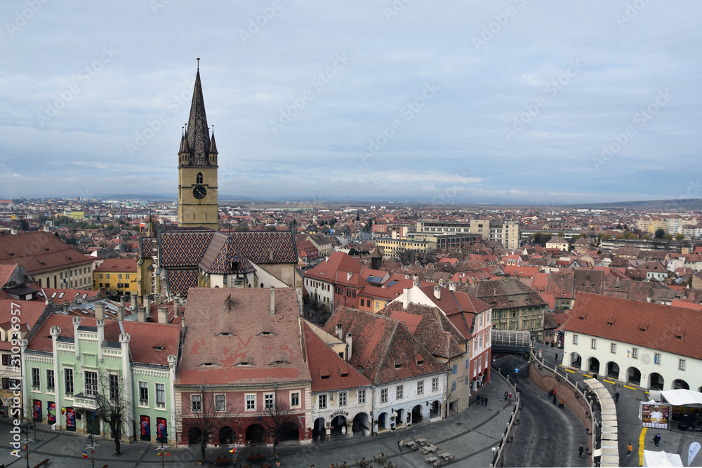 Sibiu, Romania - view from Sibiu council tower down to Mica Square, to the famous old houses with staring eyes on their roofs, to Lutheran Cathedral and the Bridge of Lies 