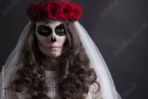 Dia de muertos catrina. Day of dead, halloween invitation card. Woman in red roses headband and veil portrait on black. Beautiful sugar skull makeup.