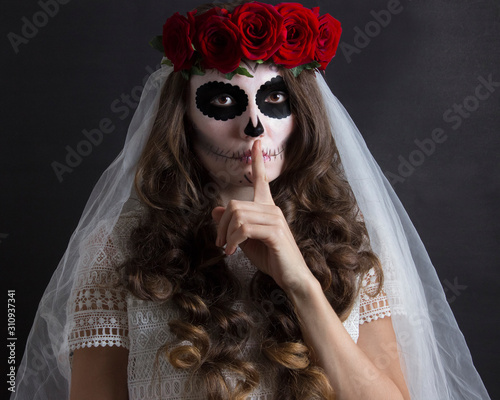 Dia de muertos catrina. Day of dead, halloween invitation card. Woman in red roses headband and veil portrait on black. Beautiful sugar skull makeup.