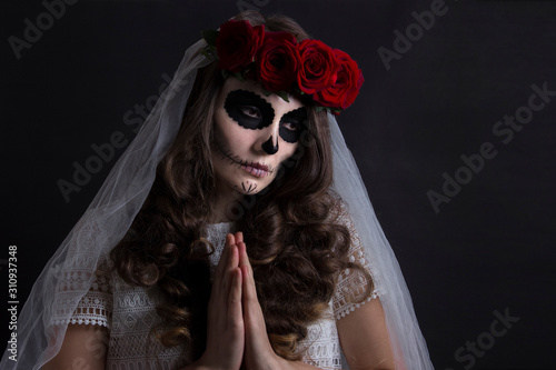 Dia de muertos catrina. Day of dead, halloween invitation card. Woman in red roses headband and veil portrait on black. Beautiful sugar skull makeup.