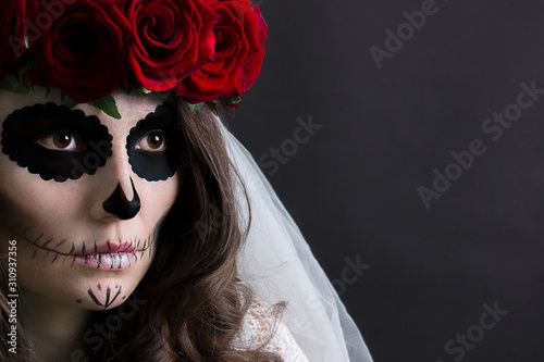 Dia de muertos catrina. Day of dead, halloween invitation card. Woman in red roses headband and veil portrait on black. Beautiful sugar skull makeup.
