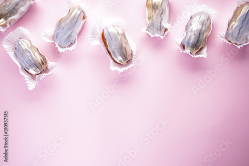 Eclairs on a pink background with place for text. French dessert.