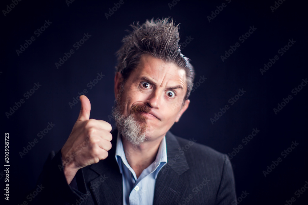 Half bearded man wearing suit showing thumb up gesture in front of black background. People and skin care concept Half bearded man wearing suit showing thumb up gesture in front of black background. People and skin care concept