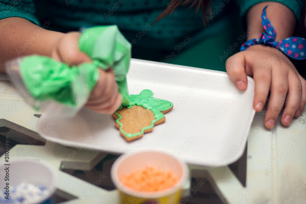 Children doing christmas decoration with hand made cookies Children doing christmas decoration with hand made cookies