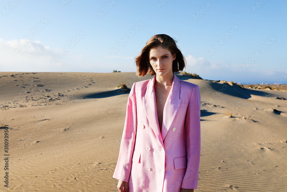 Young woman enjoying sunny weather on the beach. Outdoor photo. Young woman enjoying sunny weather on the beach. Outdoor photo.