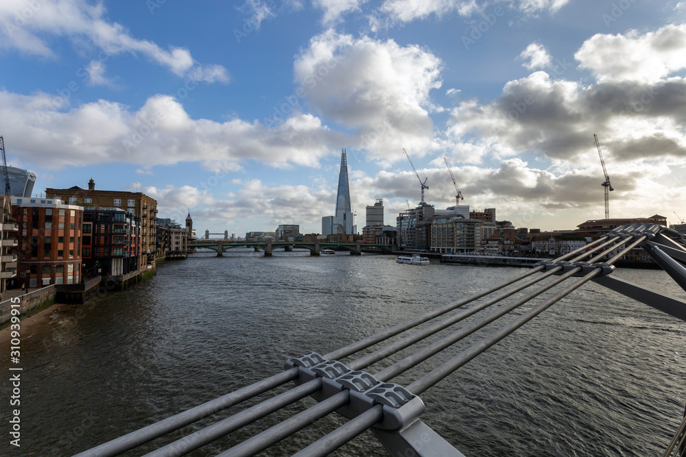 View of the south bank of river Thames with the Millennium Bridge in the foreground