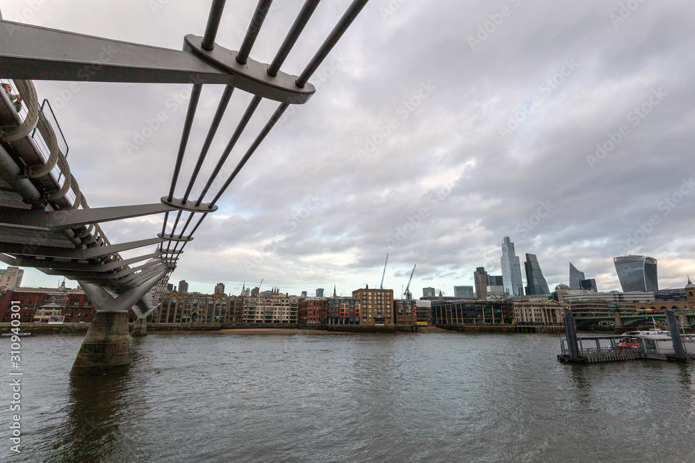View of the city of London with the river Thames and the Millennium Bridge in the foreground