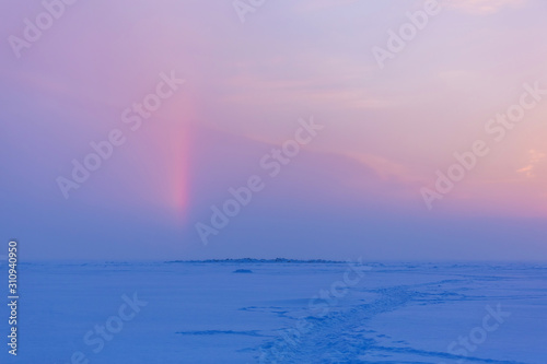 Winter evening landscape with snow-path and a sunny halo in the sky. Natural winter background. Winter pink and blue sunset © Inna