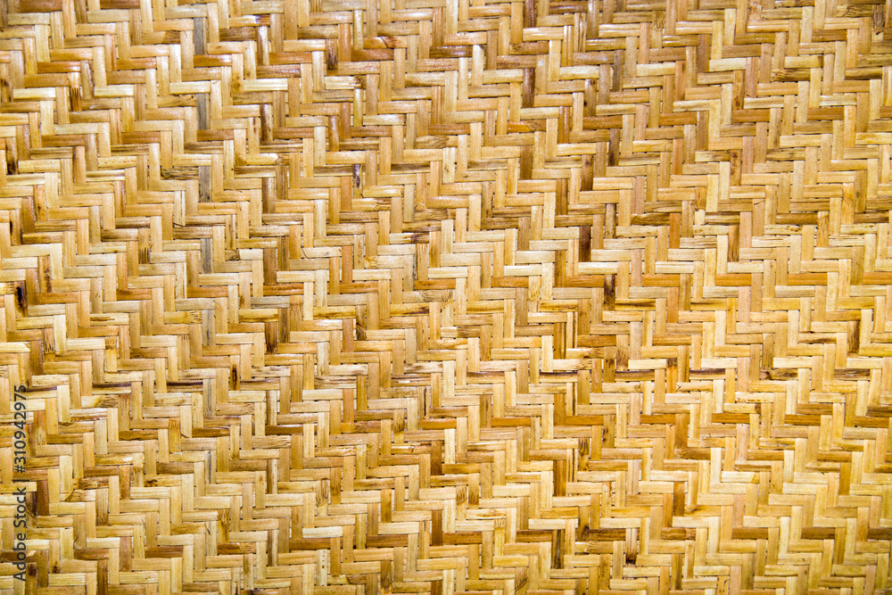 Background of woven rattan anthracite yellow and white with a beautiful pattern in the form of a ladder. Backgrounds, design, structures, textures. Background of woven rattan anthracite yellow and white with a beautiful pattern in the form of a ladder. Backgrounds, design, structures, textures.