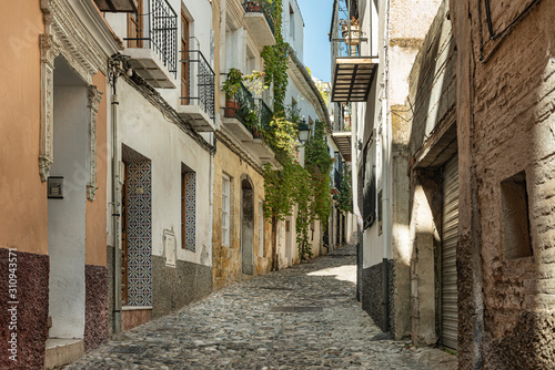 Narrow alley in the old town of Granada, Andalusia Spain. Picturesque narrow street in Granada, Spain