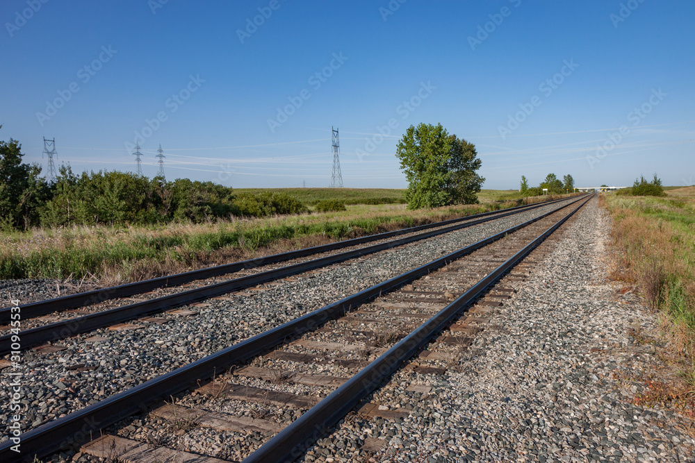 Two Pairs of Empty Railroad Tracks on Canadian Prairie