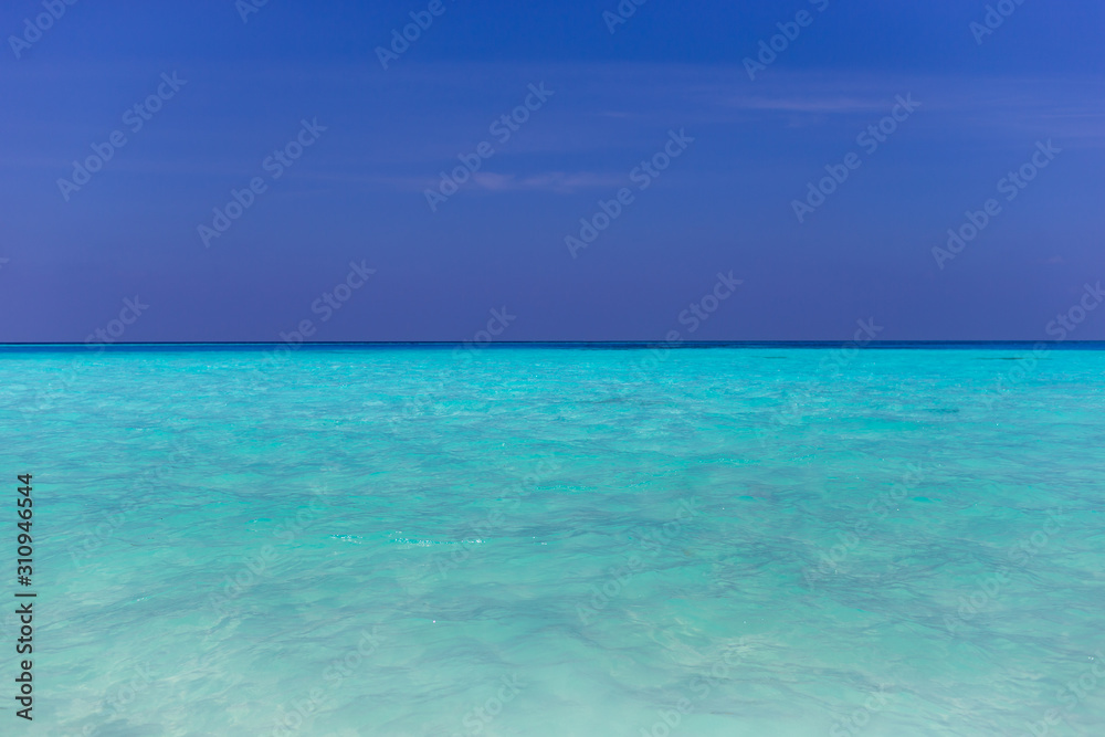 Fototapeta premium Tropical papradise beach with blue sky in sunshine day. Tropical summer beach holiday vacation lifestyle traveling, resort hotel business concept