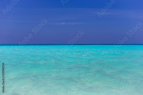 Tropical papradise beach with blue sky in sunshine day. Tropical summer beach holiday vacation lifestyle traveling  resort hotel business concept