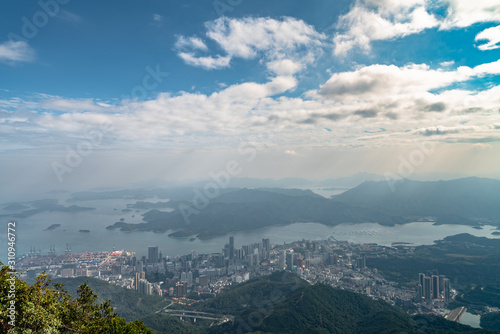 Panorama view of Shenzhen cityscape from top of Wutong Mountain on a sunny day © Peter Stein