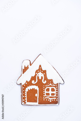 The hand-made eatable gingerbread house on white background