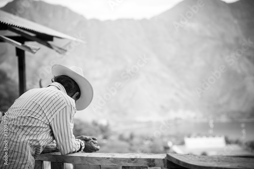 Lone farmer admires his property below in the rural mountains of Guatemala.