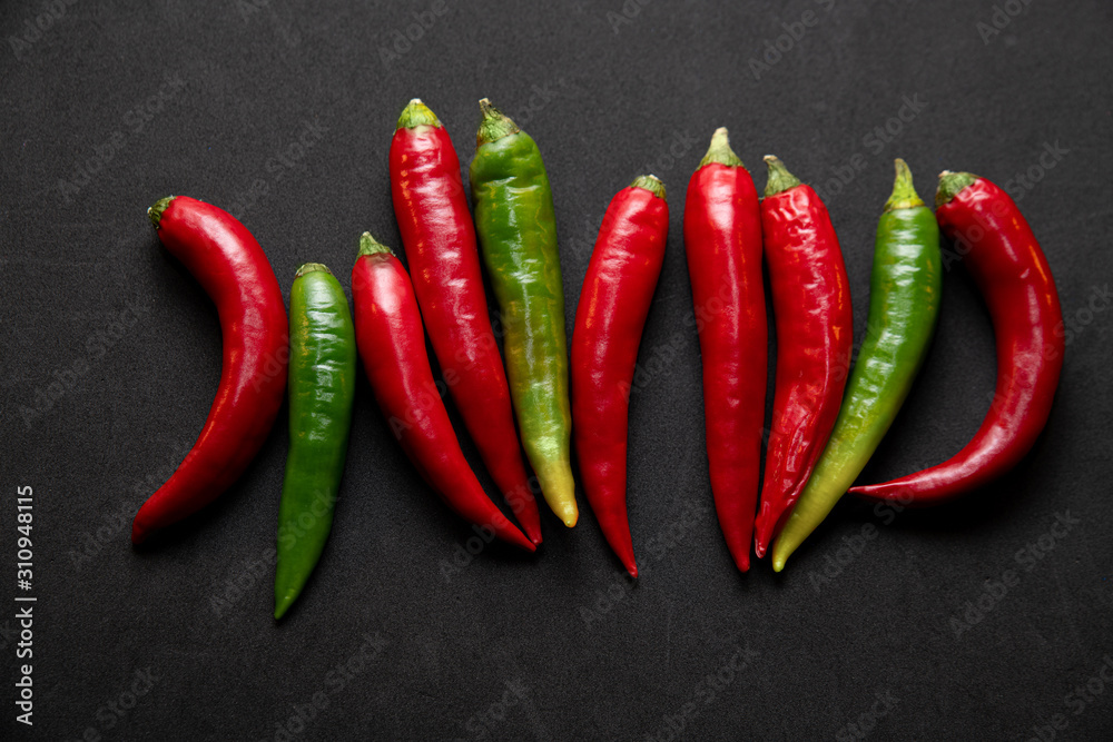 hot peppers on a black background