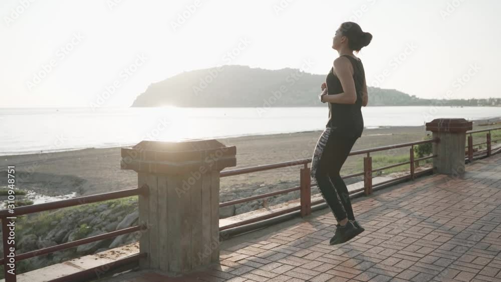 Girl warming up at sunset on the beach. Slow motion. Fitness on the beach. Girl warming up at sunset on the beach. Slow motion. Fitness on the beach.