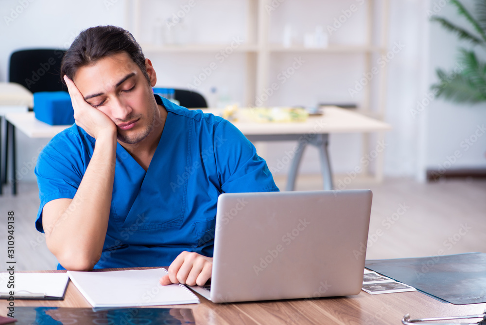 Young male doctor working in the clinic Young male doctor working in the clinic
