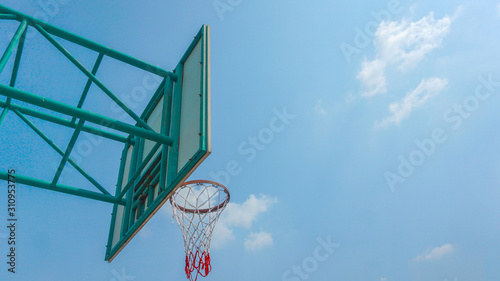 Basketball hoop and blue sky background