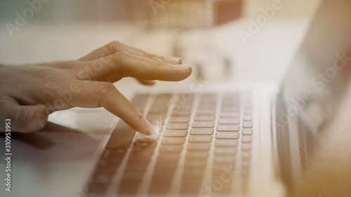 Фотография The fingertip is about to press down on the button on the laptop keyboard
