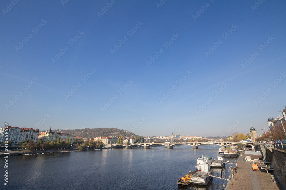 Panorama of Prague, Czech Republic, seen from the Vltava river, with a focus on Palackevo Most bridge and the riverbnaks. Prague is the main touristic destination of Central Europe
